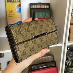 Gucci wallet with canvas/leather monogram tan and brown wallet sold as is